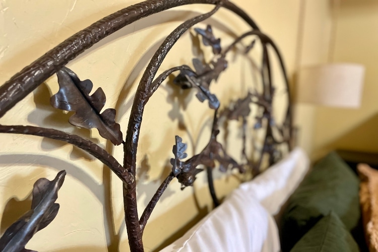 hand forged head board in Oak Cottage