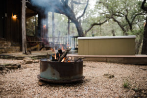 fire pit by the hot tub near the Oak Cottage.